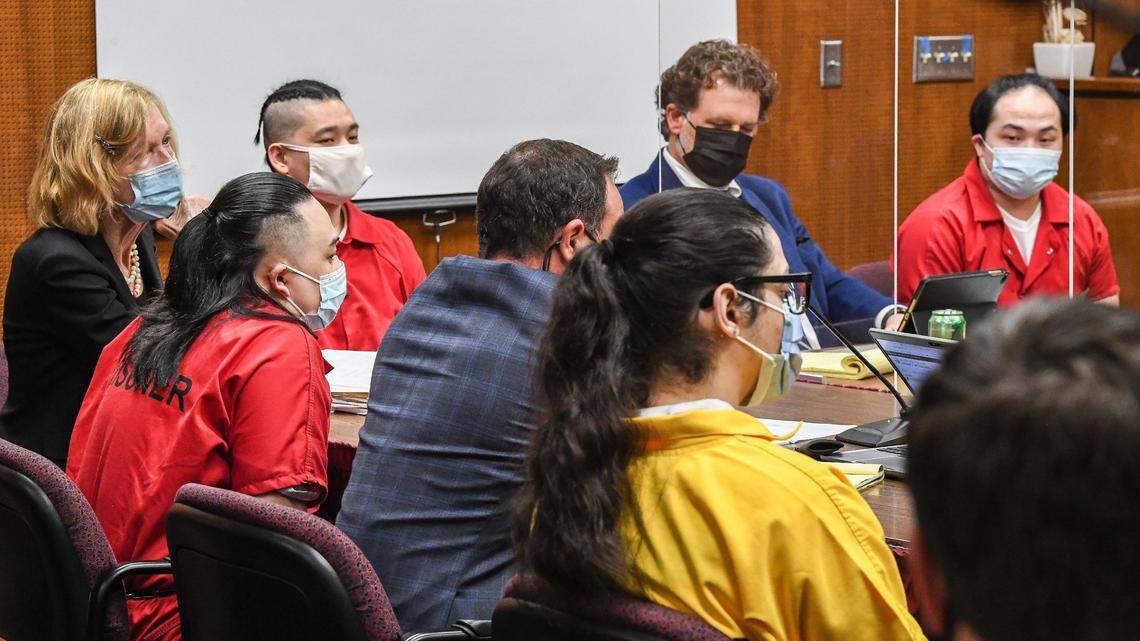 Defendants, in orange jumpsuits from left, Ger Lee, Porge Kue, and Billy Xiong and Anthony Montes, in yellow jumpsuit, listen to Judge Arian Harrell with their attorneys during the start of their preliminary hearing in Fresno County Superior Court on Tuesday, Nov. 9, 2021. The four men are charged with murdering four people in 2020 who were gathered in backyard to watch football.