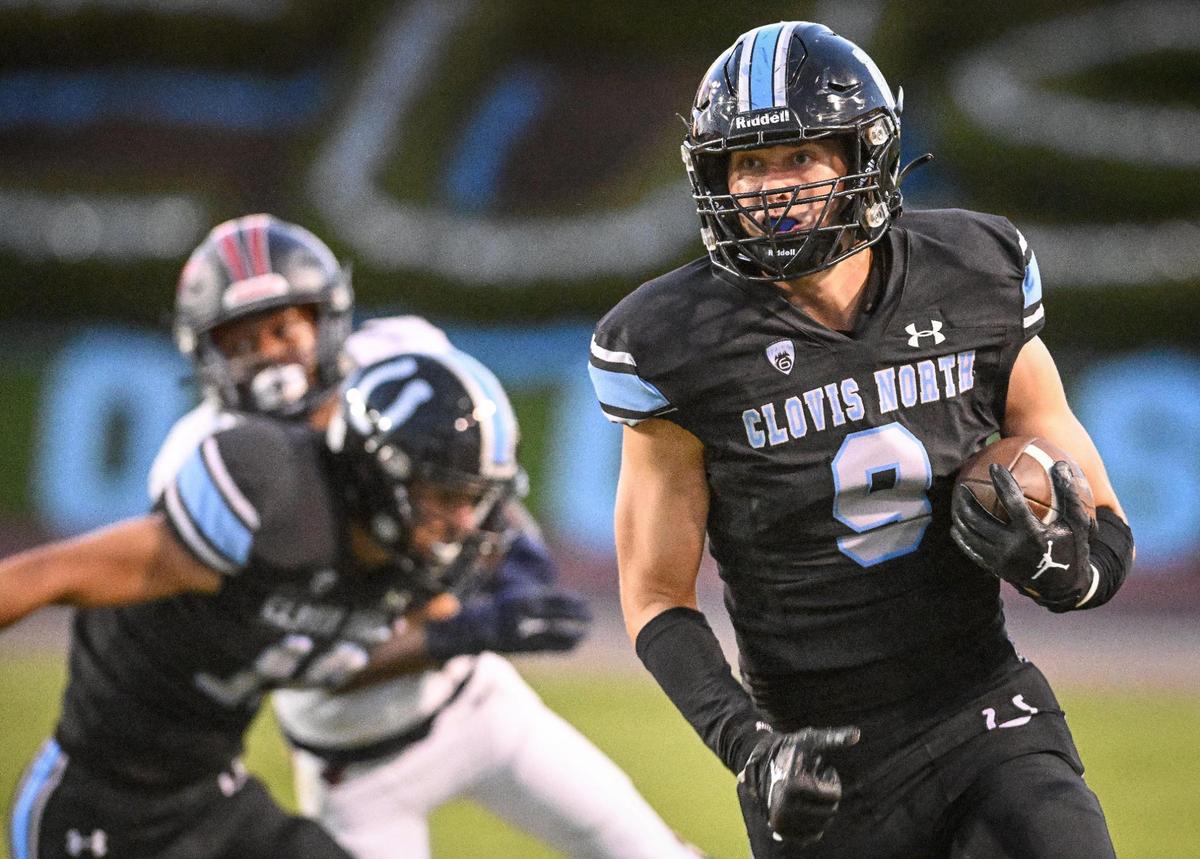 Clovis North’s Jacob Couch, right, gets a block while taking the gall down the sideline against Memorial during their game at Veterans Memorial Stadium in Clovis on Friday, Aug. 18, 2023.