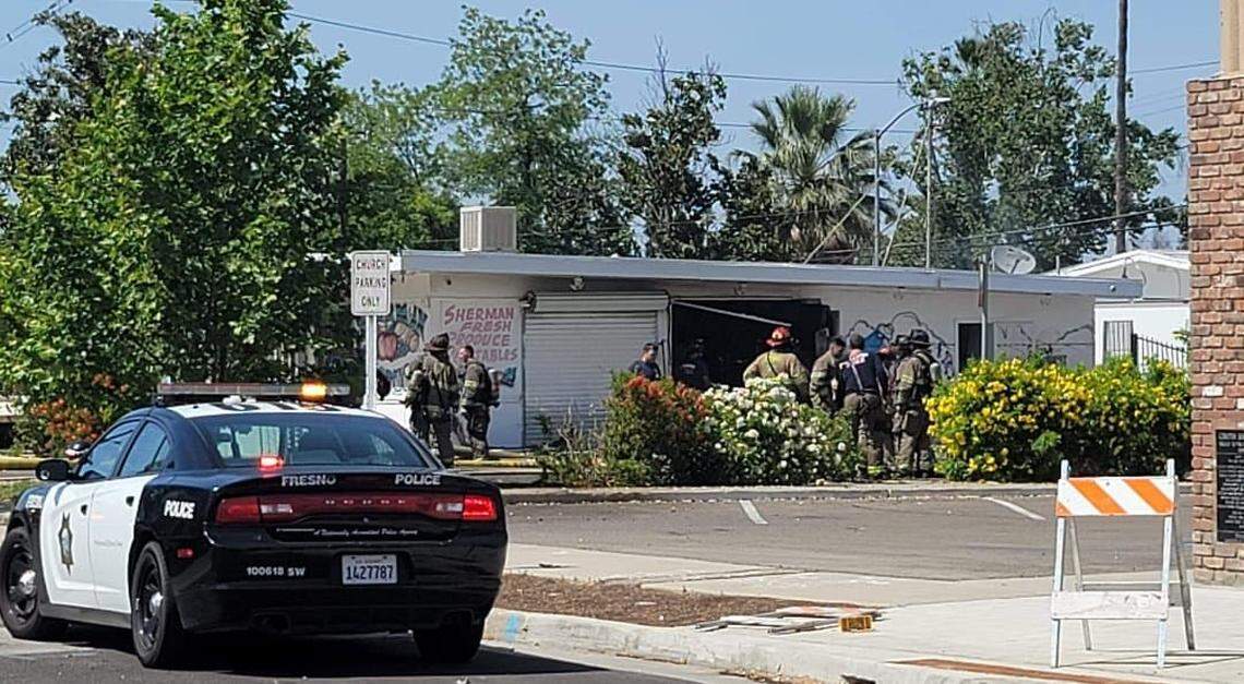Fresno Fire crews work the scene after a car crashed into a produce market in the southwest area of the city Sunday, May 9, 2021, with police saying a woman was injured but that it was still unclear if she was the driver.