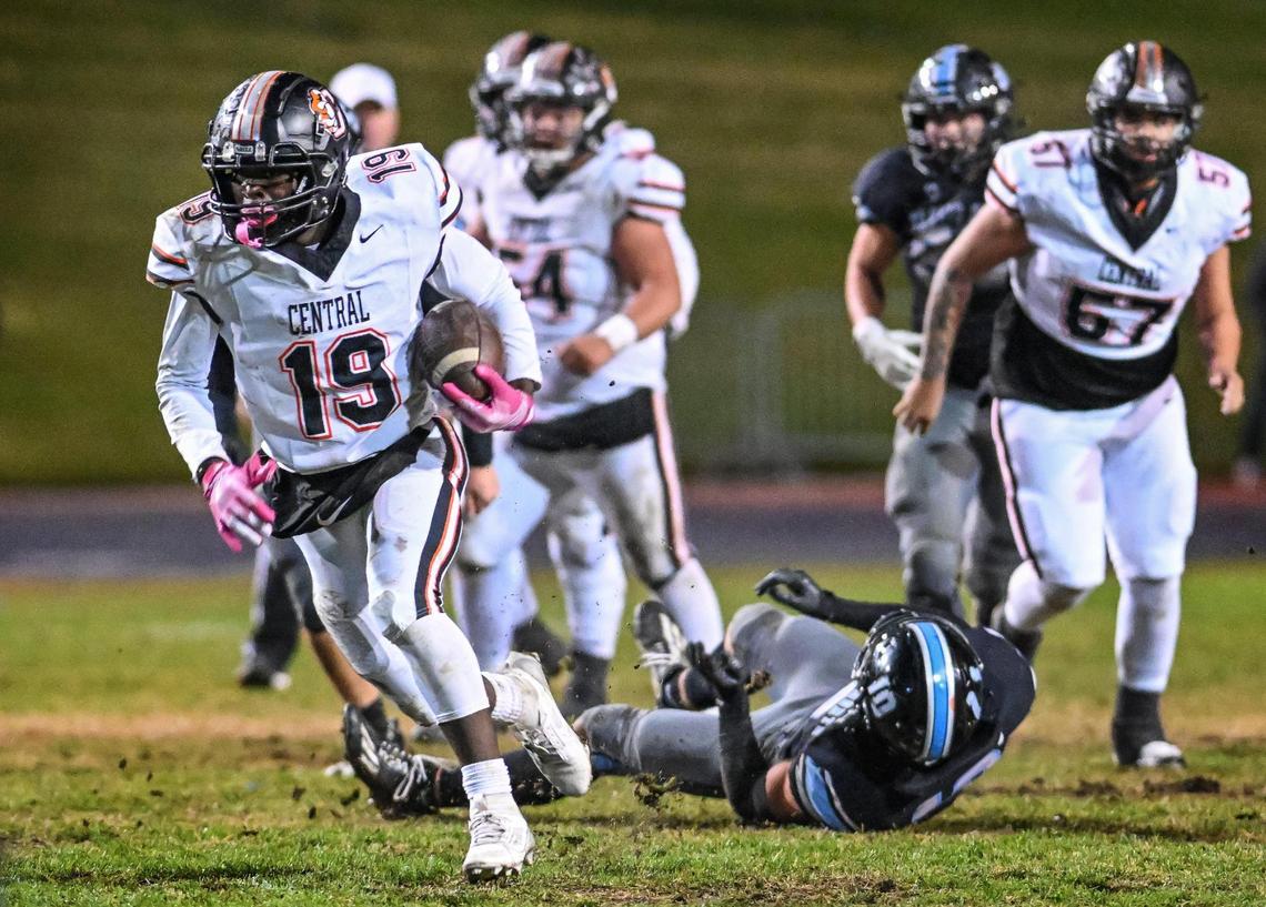 Central’s Jareal Albert, left, gains yards up the middle during their Central Section Division 1-AA semifinal game against Clovis North at Veterans Memorial Stadium in Clovis on Friday, Nov. 15, 2024.