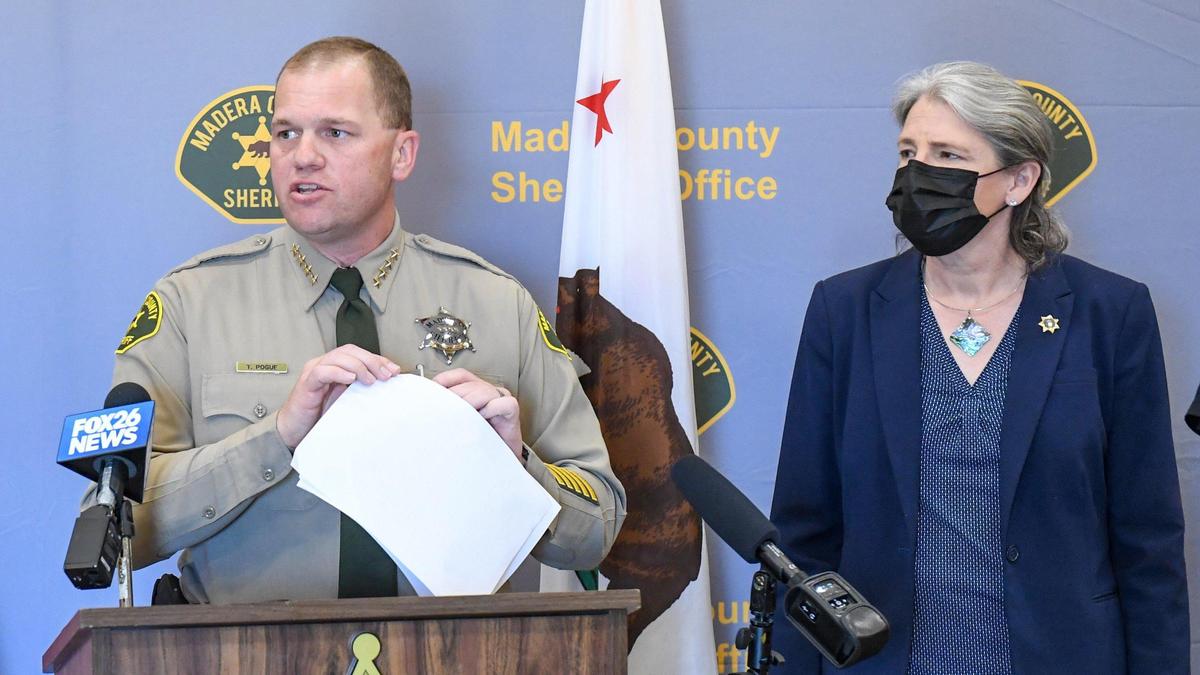 Madera County Sheriff Tyson Pogue stands near Madera County District Attorney Sally Moreno while holding a press conference to announce the results of an operation to shut down a drug-trafficking ring being run mainly out of the La Vina community of Madera County, on Monday, April 12, 2021.