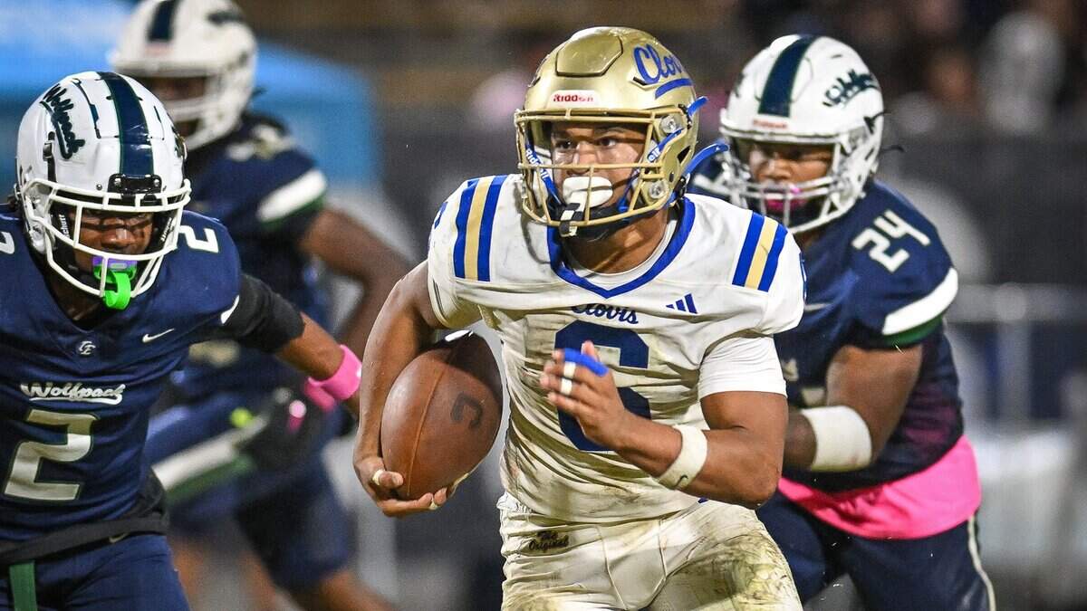 Clovis'James Curoso, center, gets past the Clovis East defense before charging into the end zone for a touchdown during their game at Lamonica Stadium in Clovis on Friday, Oct. 17, 2025.