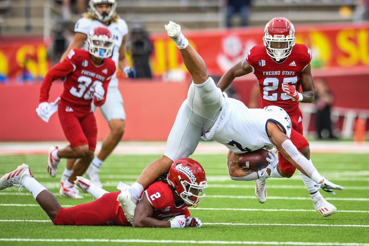 Fresno State’s Elijah Gates trips up Nevada’s Devonte Lee during their game at Bulldog Stadium on Saturday, Oct. 23, 2021.