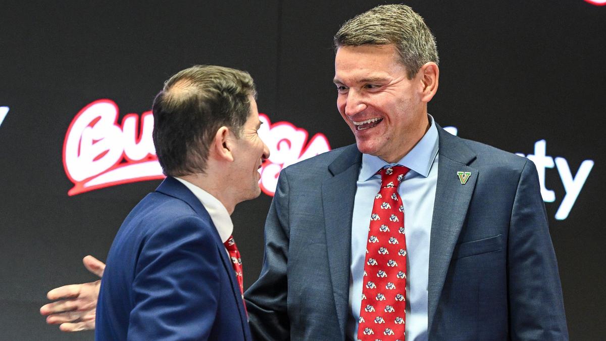 Garrett Klassy, right, is congratulated by Fresno State President Dr. Saul Jimenez-Sandoval after being announced as the university’s new athletics director during a news conference at Fresno State’s Josephine Theater on Friday, June 28, 2024.