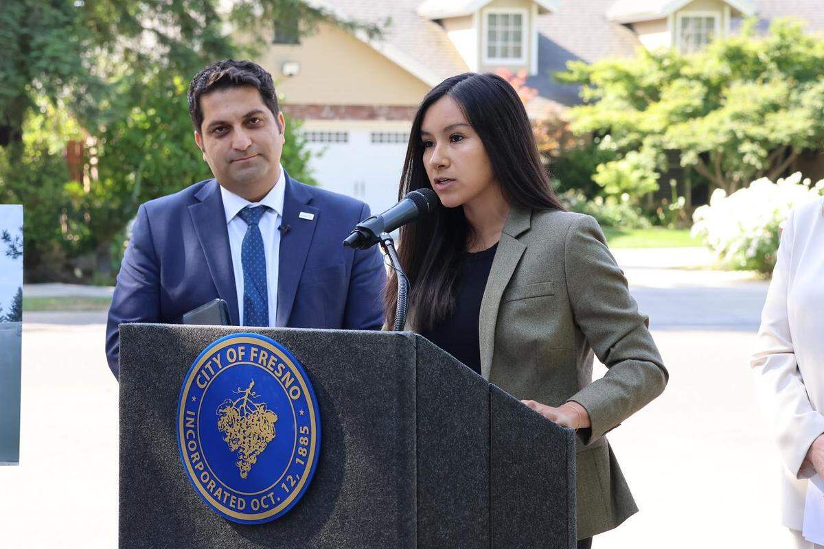Fresno City Councilmembers Annalisa Perea, speaking, and Mike Karbassi appear at a news conference.