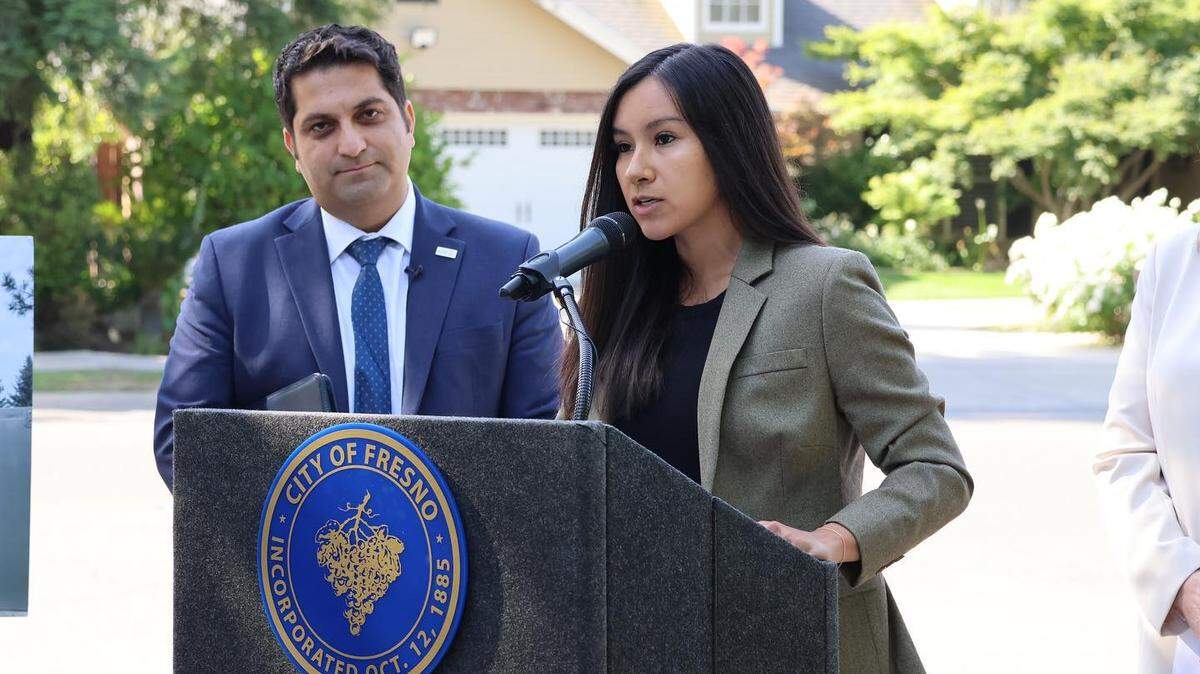 Fresno City Councilmembers Annalisa Perea, speaking, and Mike Karbassi appear at a news conference.