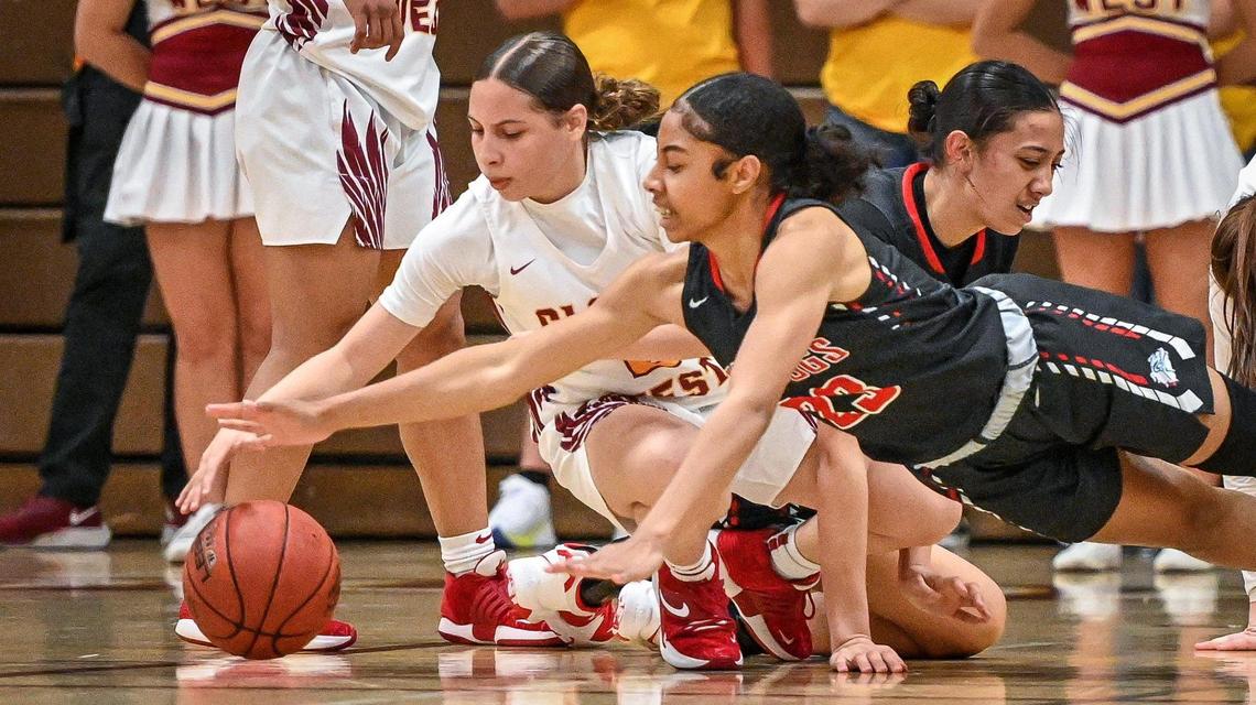 Folsom’s Jada Tupou, right, dives for the ball as Clovis West’s Ariyah Smith tries to recover a loose ball during their CIF NorCal Open Division state playoff basketball game at Clovis West on Wednesday, March 2, 2022.