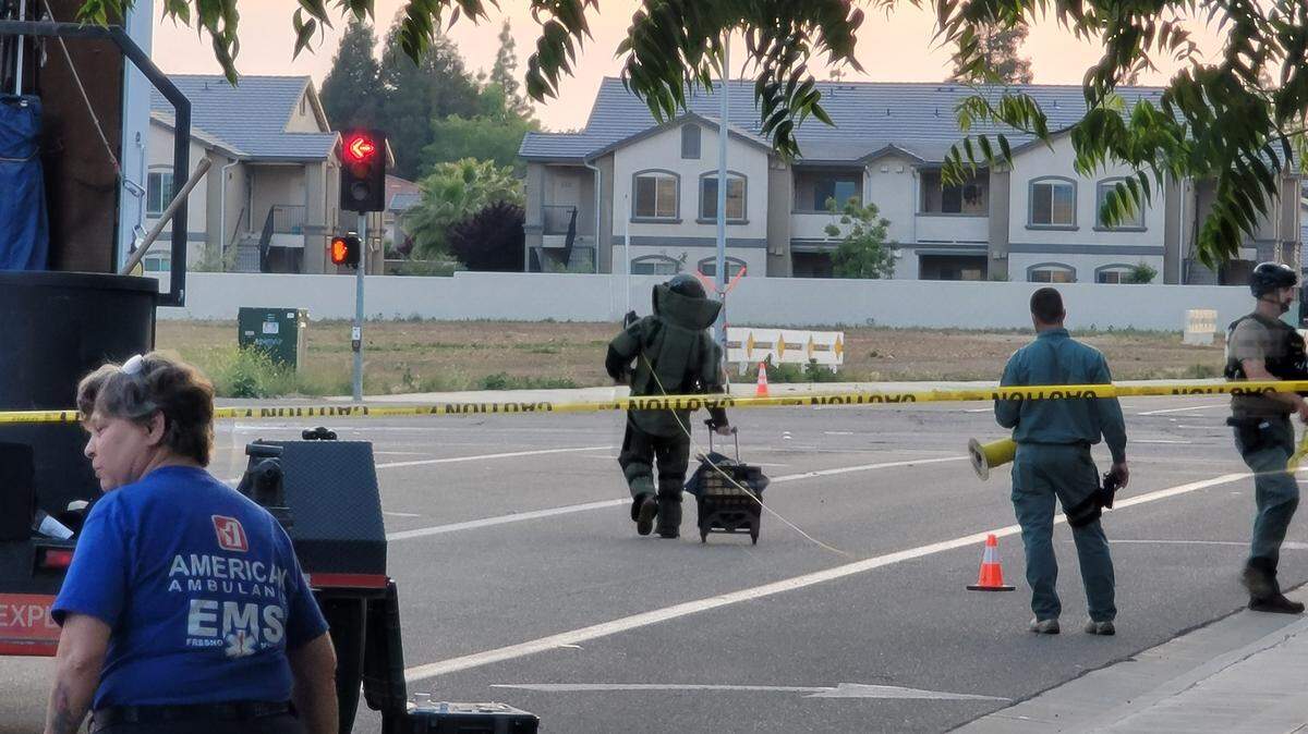 A member of the Clovis Police Bomb squad approaches a suspicious box on Monday evening, April 25.