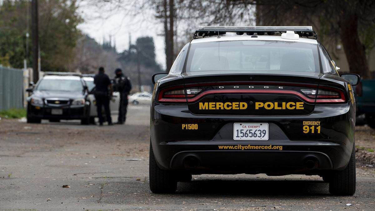 Merced police officers and detectives investigate the scene of an alleged assault earlier this year.