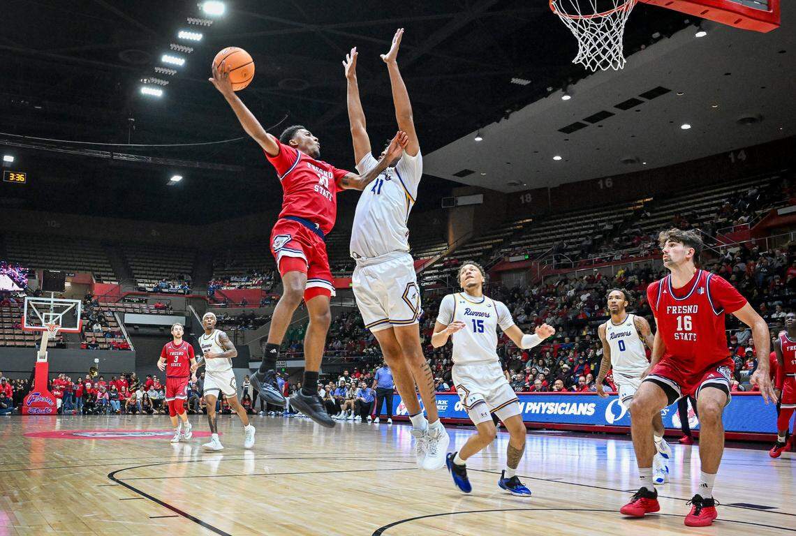 Fresno State's Zaon Collins, left, puts up a shot against CSU Bakersfield's Ronald Jessamy during their non-conference game at Selland Arena in downtown Fresno for the “Return to Selland” game on Sunday, Nov. 30, 2025.