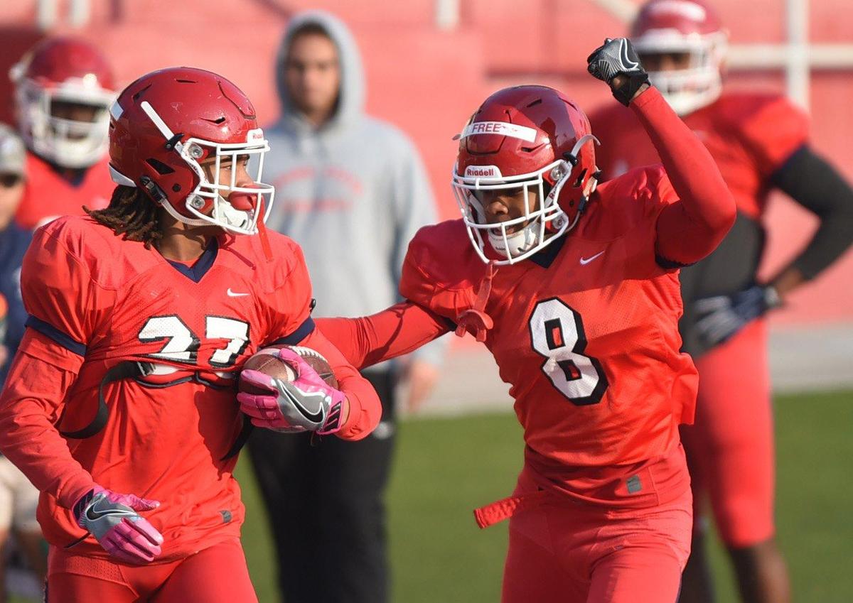 Fresno State redshirt freshman cornerback Wylan Free, right, works a ball-striping drill against Ka’Lonn Milton, during a practice.