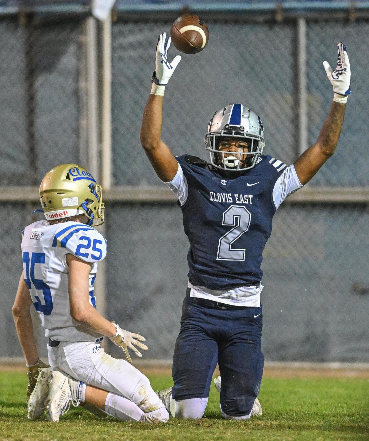 Clovis East’s Harold Duvall, right, celebrates after catching the ball in the end zone for a touchdown with Clovis’ Dalton Byrd defending the play during their game at Lamonica Stadium on Friday, Oct. 20, 2023.