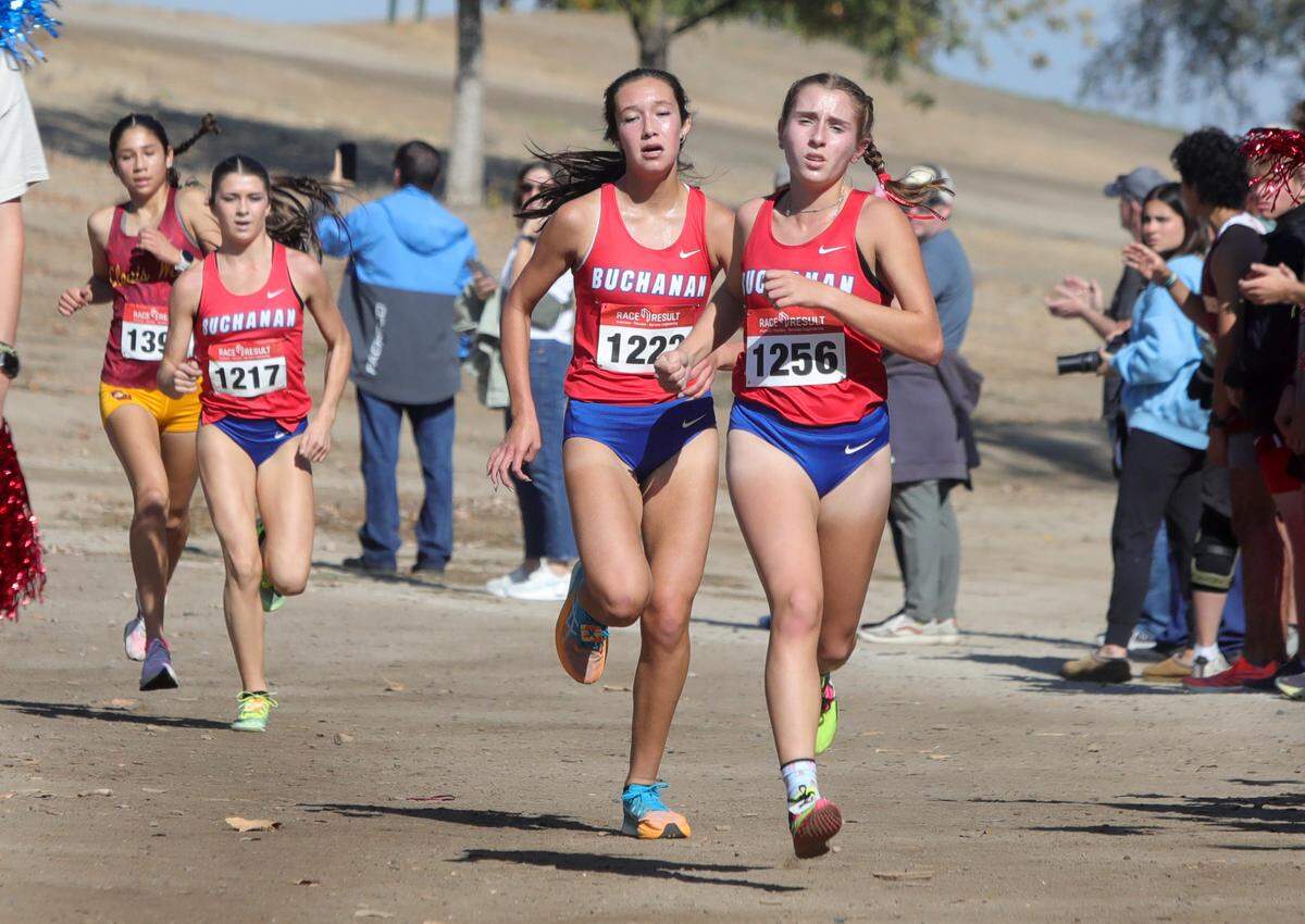 Buchanan High teammates Sierra Cornett and Stefania Sesock run together with a mile left in the TRAC cross country championship at Woodward Park on Nov. 9, 2023. Secock won, Cornett was second.