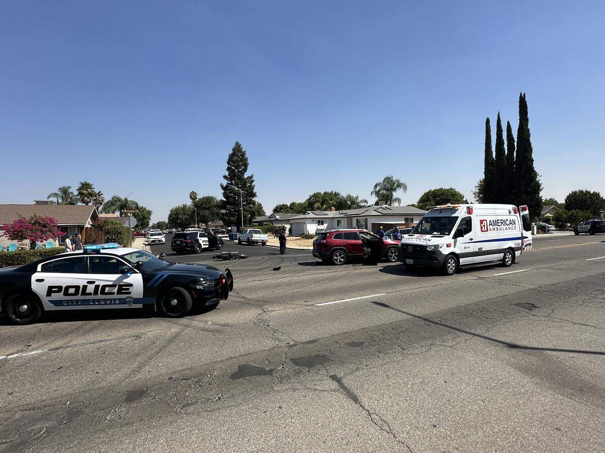 Clovis police officers investigate the scene where a man on a motorcycle was killed in a collision with an SUV on Wednesday, Aug. 28, 2024. Police said the woman in the SUV was arrested on suspicion of DUI.