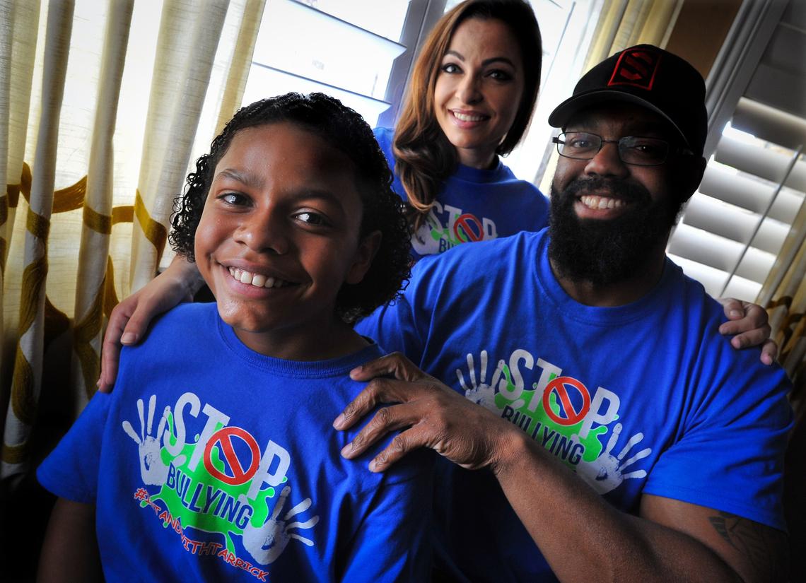 Tarrick Walker, 12, with his parents Marcel and Darlene Walker, are taking a stand against bullying after Tarrick was called a racial slur while playing basketball at his Hanford school.