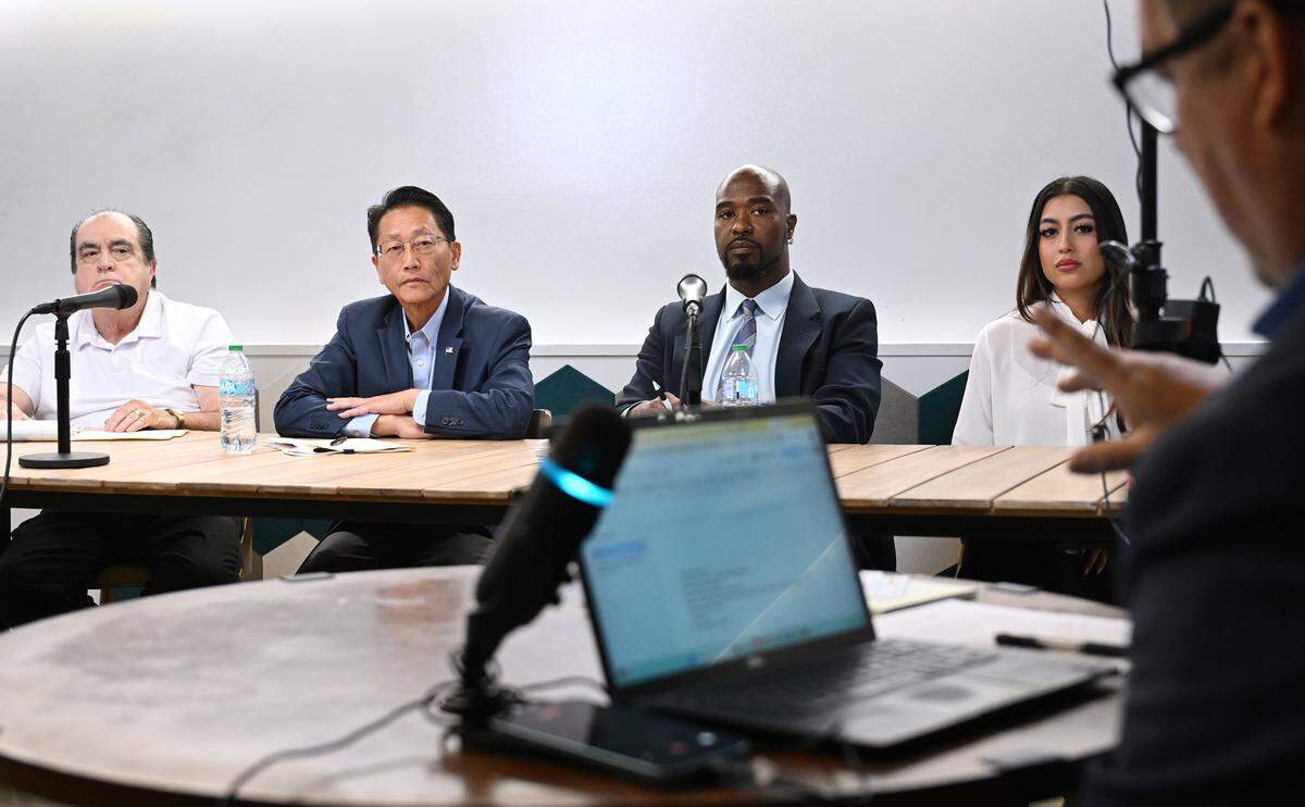 Fresno City Council District 5 candidates left to right, Jose Leon Barraza, Brandon Vang, Nicholas Wildstar and Danielle Parra listen to a question posed by the Bee's Christopher Kirkpatrick during a candidate forum held Friday, April 17, 2026 in downtown Fresno