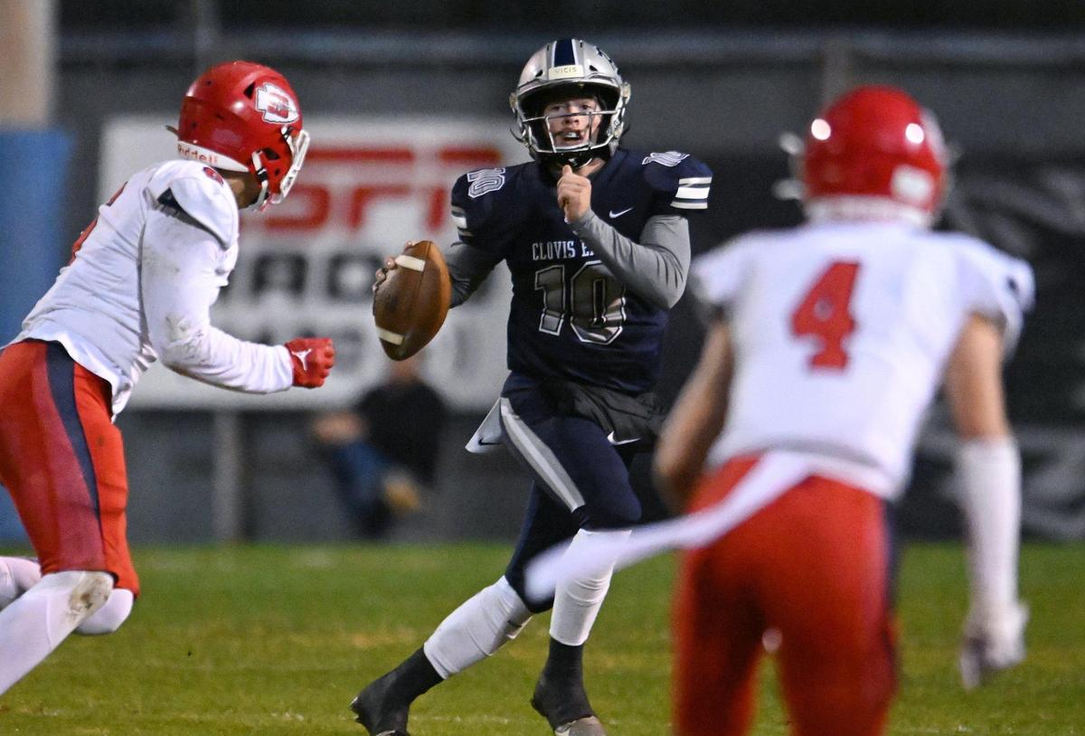Clovis East quarterback Tyus Miller, center, scrambles as he’s pressured by Sanger’s Conner Bohlken, left, and Jacob Niemeyer, right, in a Central Section Division I quarterfinal game Thursday, Nov. 9, 2023 in Clovis.