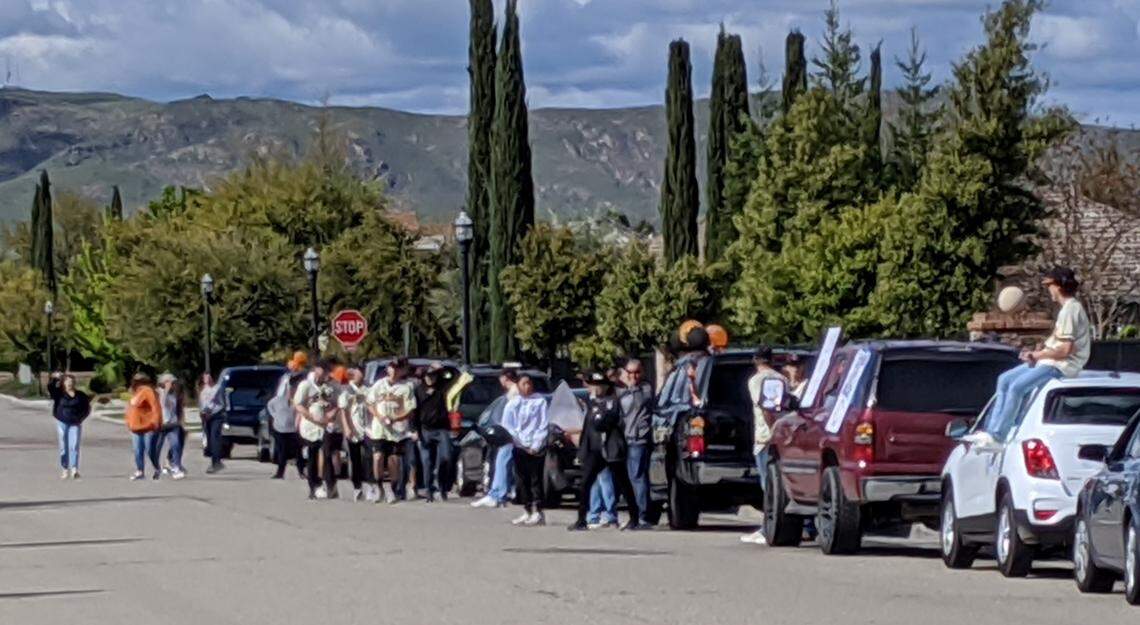People gather at the intersection of Sanders and Powers avenues near Bud Rank Elementary School in Cloivs on Thursday, April 9, despite guidance encouraging social distancing. Such gatherings, as well as impromptu neighborhood car “parades,” are an ongoing concern for county health officials who fear it could increase the risk for spreading the novel coronavirus.