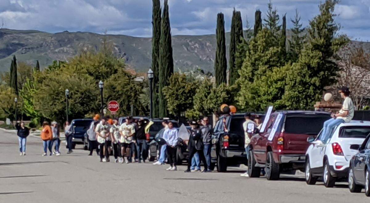 People gather at the intersection of Sanders and Powers avenues near Bud Rank Elementary School in Cloivs on Thursday, April 9, despite guidance encouraging social distancing. Such gatherings, as well as impromptu neighborhood car “parades,” are an ongoing concern for county health officials who fear it could increase the risk for spreading the novel coronavirus.