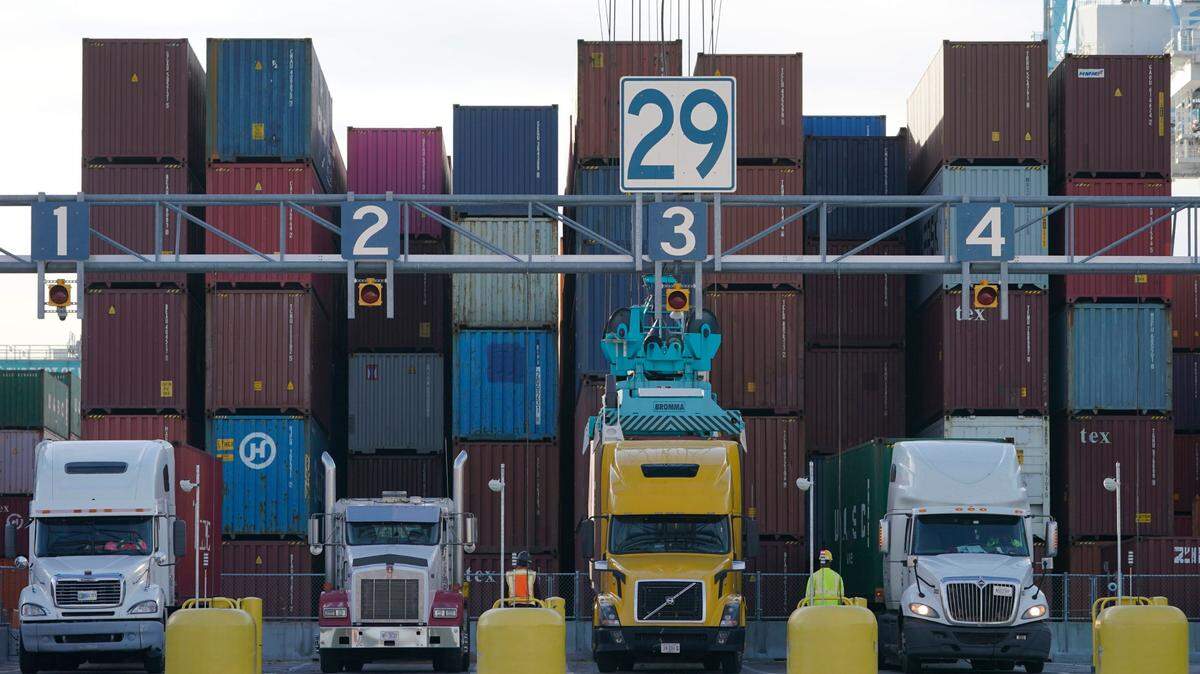 Trucks line up to have containers loaded from a stack at the Norfolk International Terminal in December in Norfolk, Virginia.
