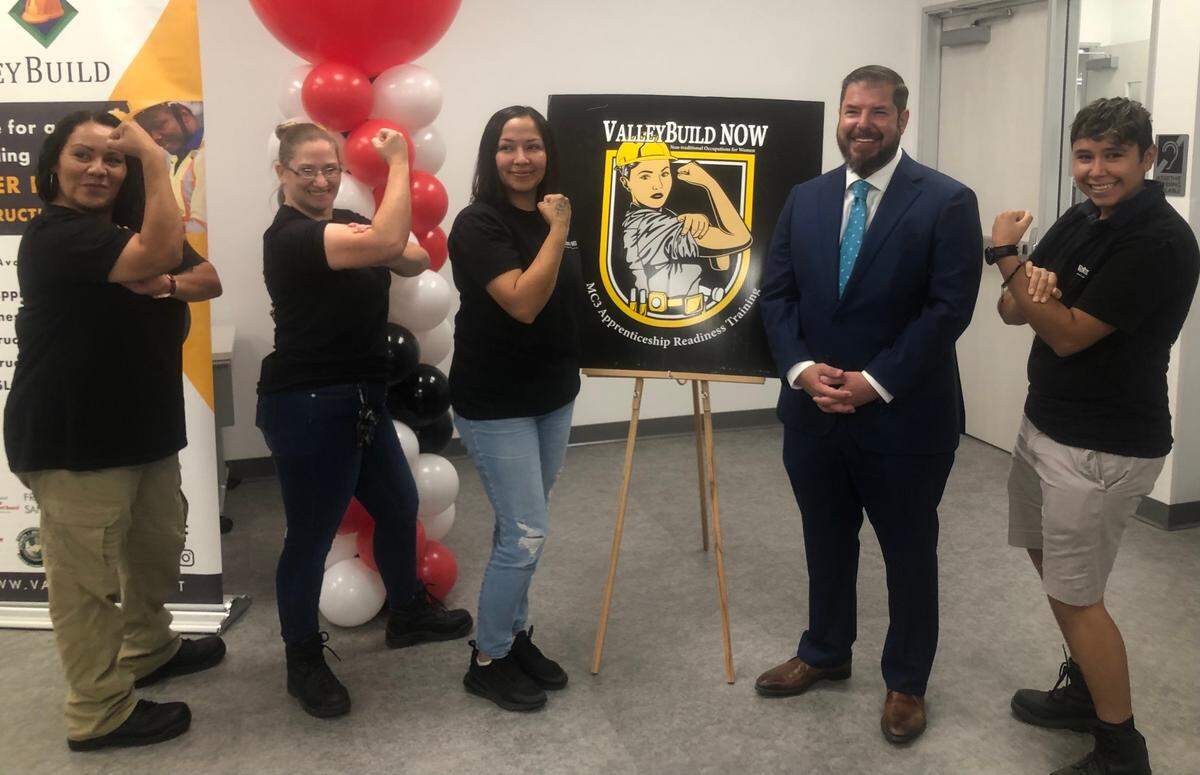 Sarai Ayala, right, and other ValleyBuild NOW graduates pose with Assemblymember Joaquin Arambula during a press conference announcing $3 million in state funding for the Fresno Regional Workforce Development Board on October 12, 2022.