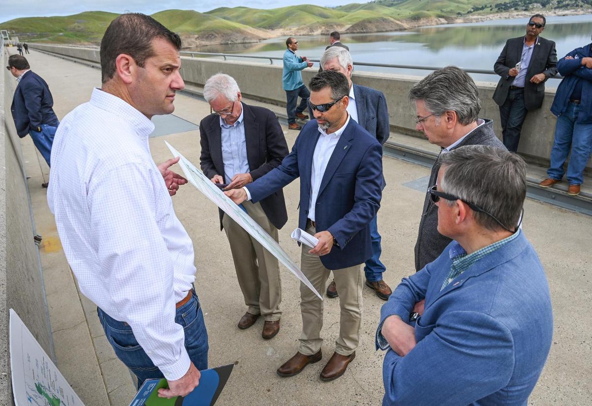 Congressman David Valadao, left, is joined by fellow Republicans Tom McClintock, second from left, and John Duarte, second from right, as well as Bruce Westerman, chairman of the House Committee on Natural Resources, Cliff Bentz, chairman of the House Subcommittee on Water, Wildlife and Fisheries, and Jason Phillips, center, CEO of the Friant Water Authority, as they discuss water storage on a tour on top of Friant Dam in Friant in April 2023.