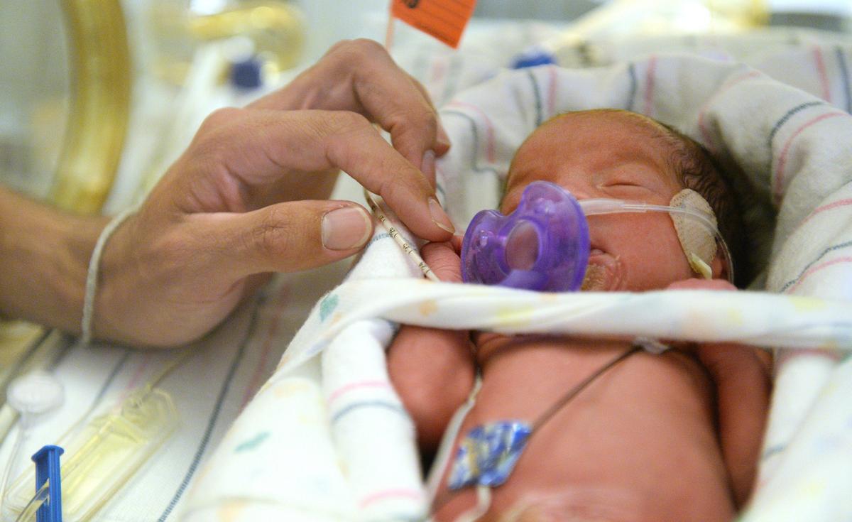 Elesandro Flores Jr. spends some time with his newborn daughter Quinn in the NICU at Community Regional Medical Center in Fresno on Tuesday, Oct. 30, 2018.