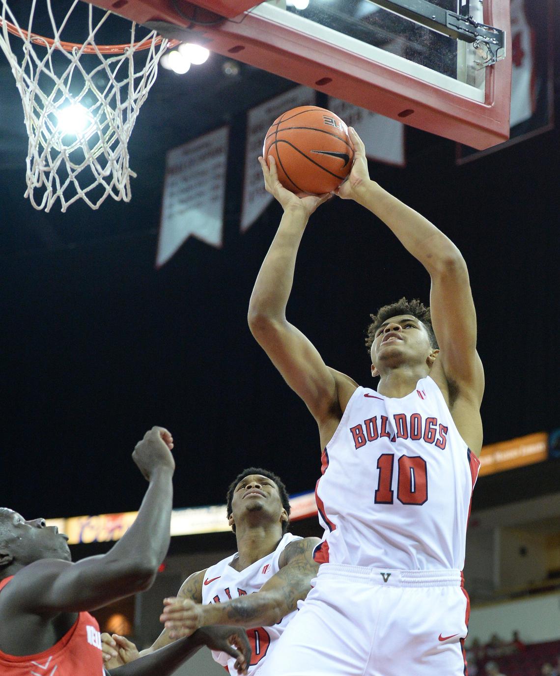 Fresno State freshman Orlando Robinson, right, goes to the hoop against New Mexico in the Bulldogs’ 82-77 victory over the Lobos at the Save Mart Center in February. Robinson had 20 points and 15 rebounds in the game.