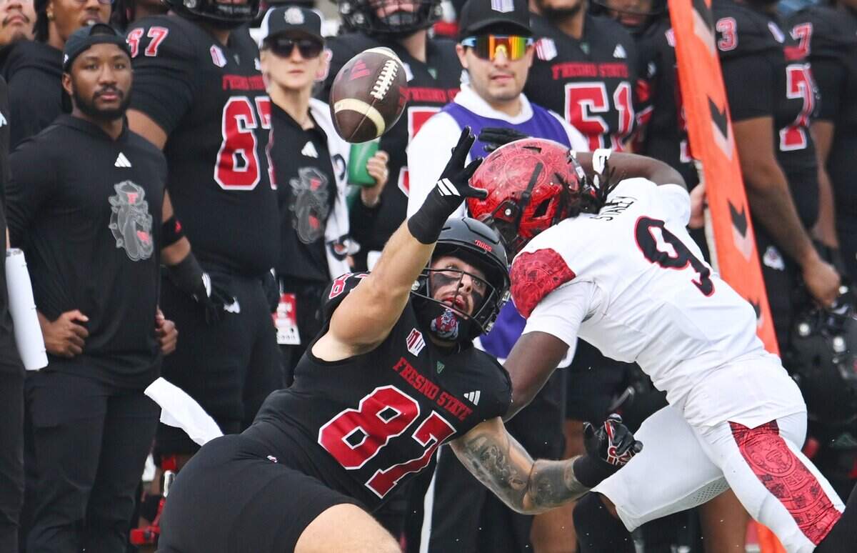 A pass intended for Fresno State's Jake Tarwater, left, is tipped by San Diego State's Dalesean Staley, right, Saturday, Oct. 24, 2025 in Fresno.