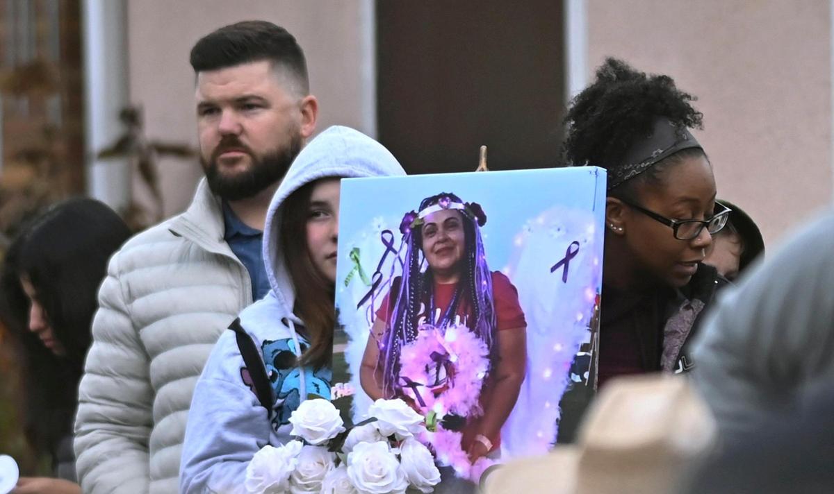 A framed photo of Guadalupe Bond is seen as hundrerds in the community gathered in front of the Bond house for a candlelight vigil following the murder of four Bond family members including Guadalupe Bond Friday evening, Jan. 12, 2024 in Reedley.