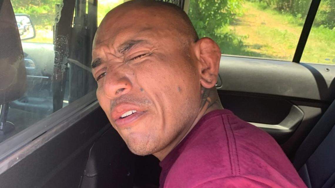 John Mathison, 41, of Kingsburg sits handcuffed in a Fresno County Sheriff’s Office patrol car after his arrest for allegedly driving under the influence.