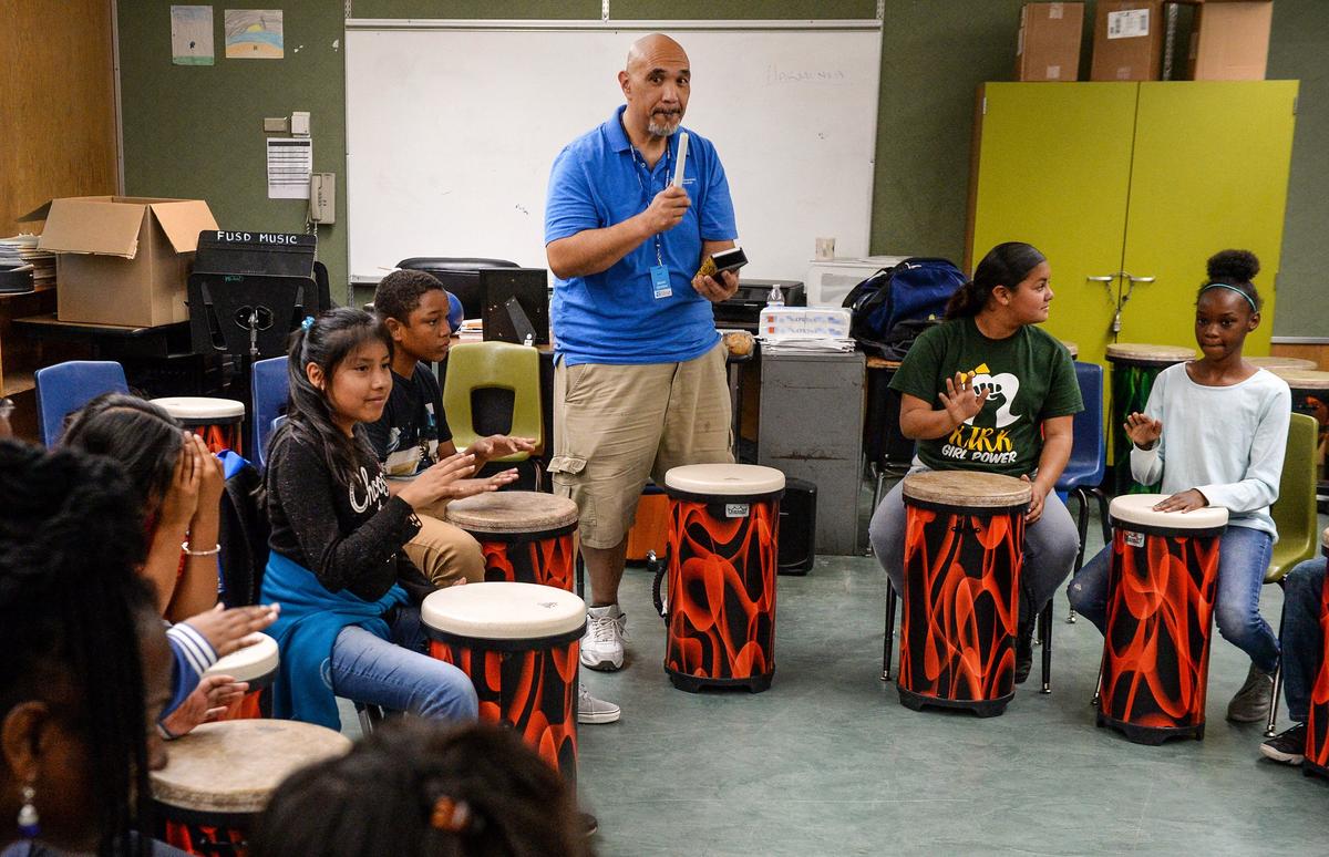Brian Semsem, center, gets the beat going with his cowbell as Kirk Elementary School sixth graders participate in a drum circle class on Wednesday, May 9, 2019.