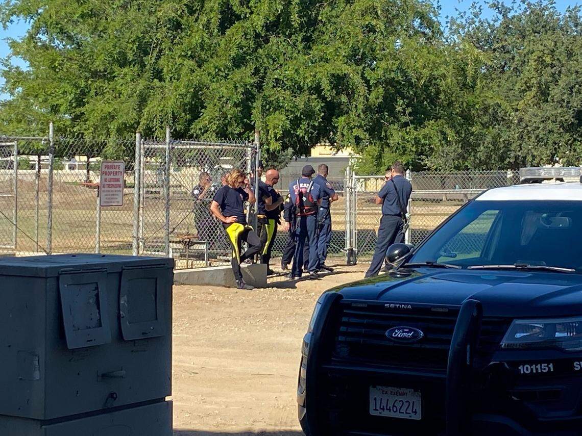 First responders check a canal where a body was discovered Tuesday, June 14, 2022, in Fresno, California.