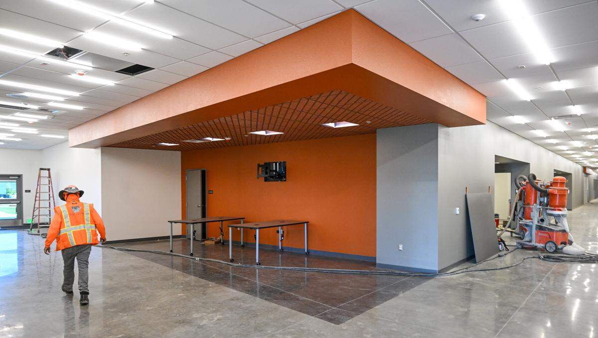 A construction worker walks through the hallway of a classroom building at Phillip V. Sanchez Intermediate School, part of the Terry P. Bradley Educational Center, on Friday, Aug. 8, 2025 just days before the start of classes on August 18. 