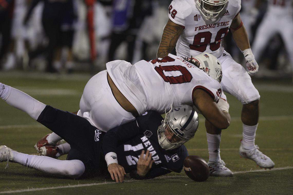 Fresno State defensive tackle Kevin Atkins tries to recover a fumble by Nevada quarterback Carson Strong in the Bulldogs’ 37-26 loss to the Wolf Pack Saturday, Dec. 5, 2020.