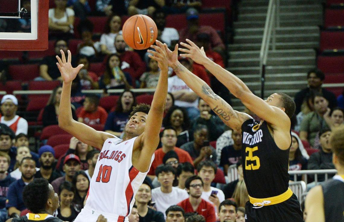 Fresno State’s Orlando Robinson, left, defends against Winthrop’s Josh Ferguson during their home opener at the Save Mart Center in Fresno on Sunday.