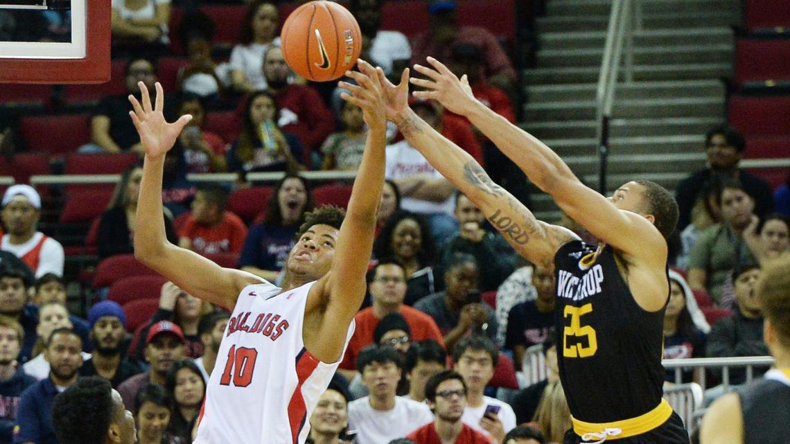 Fresno State’s Orlando Robinson, left, defends against Winthrop’s Josh Ferguson during their home opener at the Save Mart Center in Fresno on Sunday.