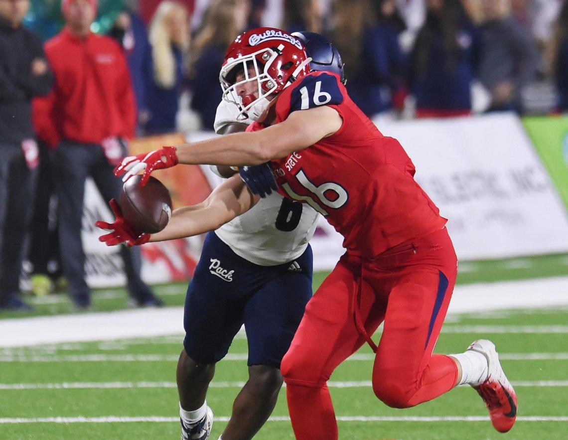 Fresno State tight end Jared Rice makes a catch on third down while covered by Nevada’s Tyson Williams, Saturday, Nov. 23, 2019 in Fresno. Rice caught five passes for 71 yards in the Bulldogs’ 35-28 loss, setting a school record for receiving yards by a tight end.