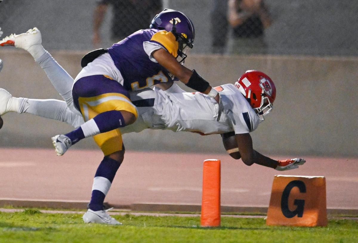 Sanger’s Bryson Baker, right, carries the ball in for a touchdown covered by Lemoore’s Jarrick Lewis, left, Friday, Sept. 8, 2023 in Lemoore. Sanger dominated Lemoore in the 42-13 win.
