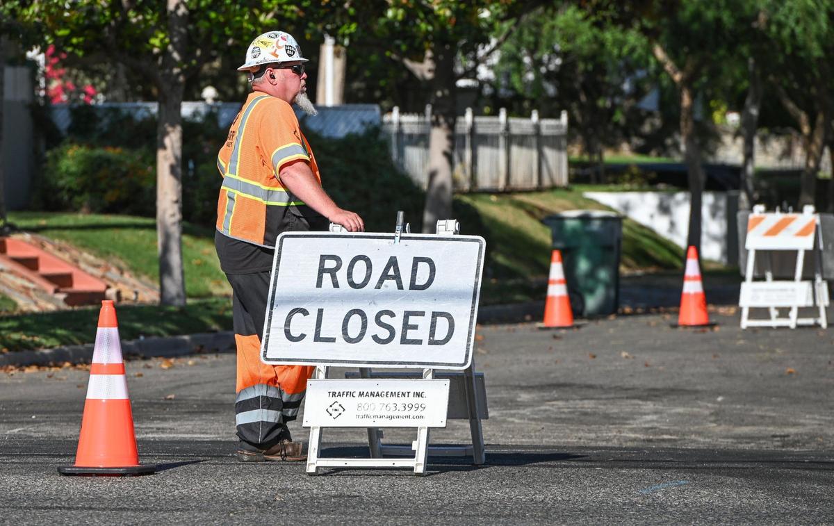 Workers closed access to streets along Palm Avenue south of Shields as they prep for the construction on new bike lanes on Friday, May 19, 2023.