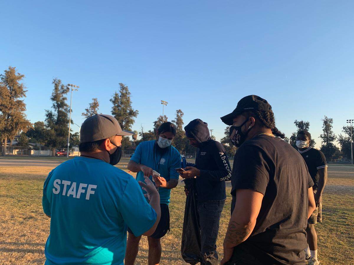 Kieshaun White talks with PARCS staff about his Fresno Clean Up project in Holmes Playground.