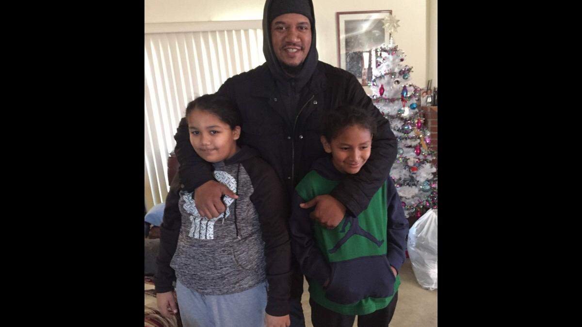 Christopher Walker and his twin sons, Neeko and Chris Walker Jr., seen in an undated photo. The elder Walker was on foot when struck and killed by a Fresno police officer driving a cruiser on Jan. 5, 2023.