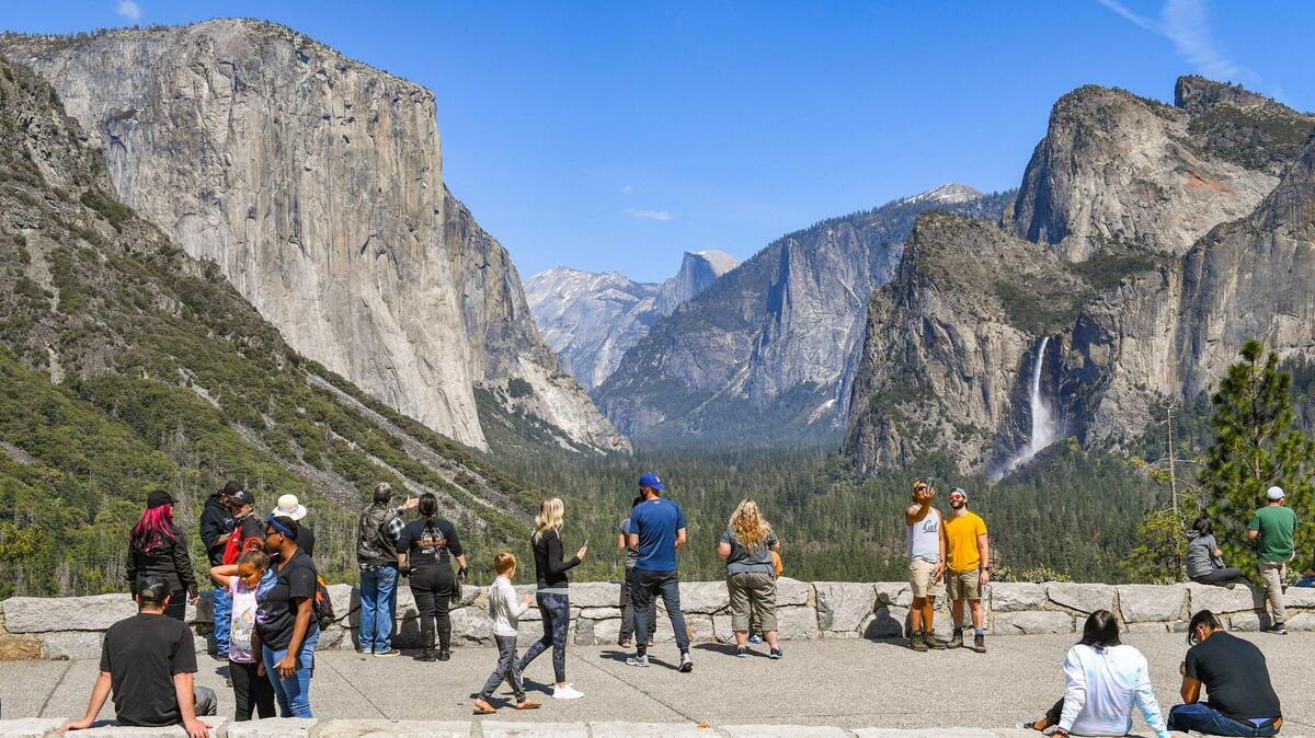 Visitors take in the splendor of Yosemite Valley at Tunnel View in Yosemite National Park on a spring day in 2021.