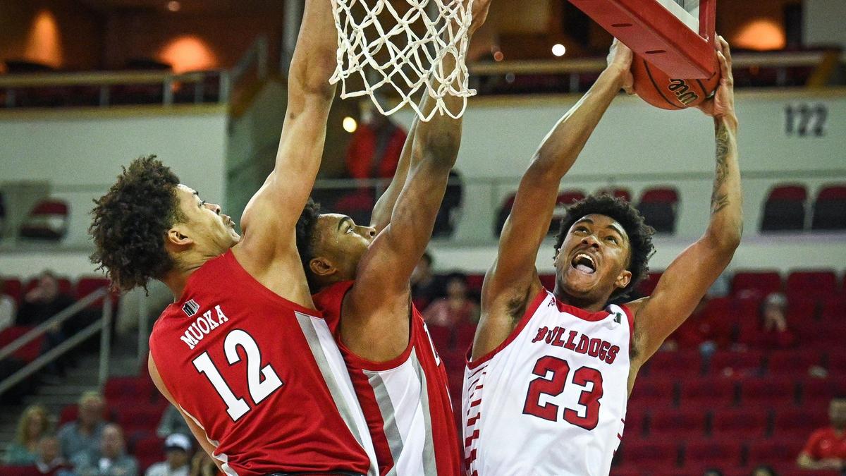 Fresno State’s Leo Colimerio, right, tries to find an angle on the hoop but gets blocked out by UNLV’s David Muoka, left, and Bryce Hamilton during their game at the Save Mart Center in Fresno on Wednesday, Feb. 16, 2022.