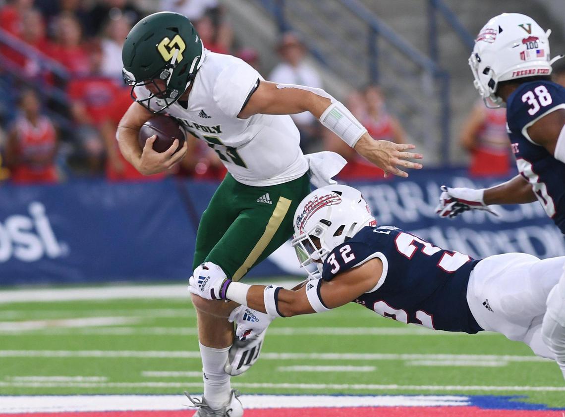 Fresno State safety Evan WIlliams, right, tackles Cal Poly quarterback Spencer Brasch, right, Saturday, Sept. 11, 2021 in Fresno.