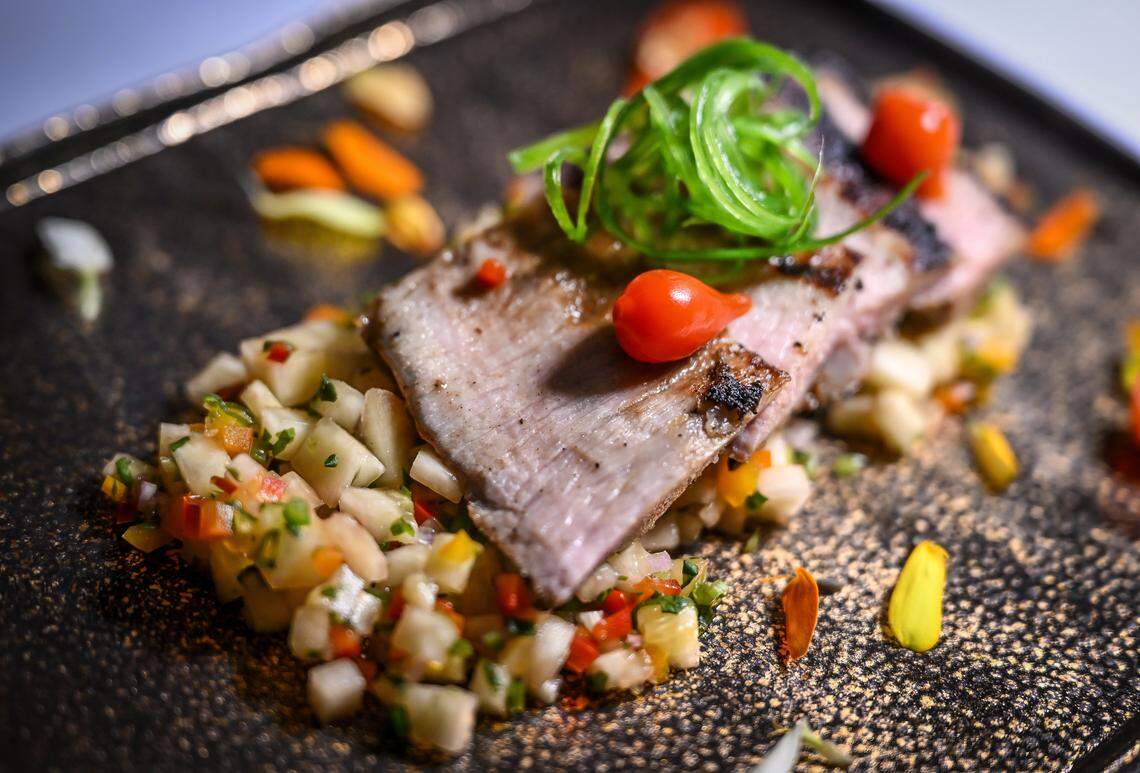 Iberian pork secreto made with roasted citrus marinated pork and pineapple glaze is displayed during a media event to promote The PM Lounge, a new members-only club that promises to bring high-level dining experiences and live entertainment to its guests.
