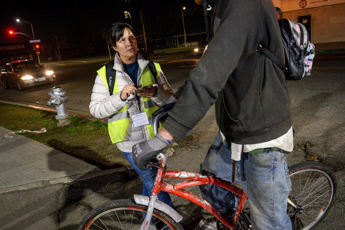 Homeless survey volunteer Aimee Bird gathers survey information from a homeless man who was riding a bike through the Lowell neighborhood of Fresno during the Point-in-Time homeless count hosted by the Fresno Madera Continuum of Care, on Wednesday, Jan. 29, 2020.