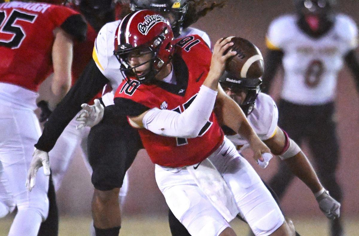 Hanford’s Daniel Gomez is pressured by Tulare Union’s Dominic Wilson and Nathan Cordova, background, in first half action Friday, Oct. 11, 2024 in Hanford.