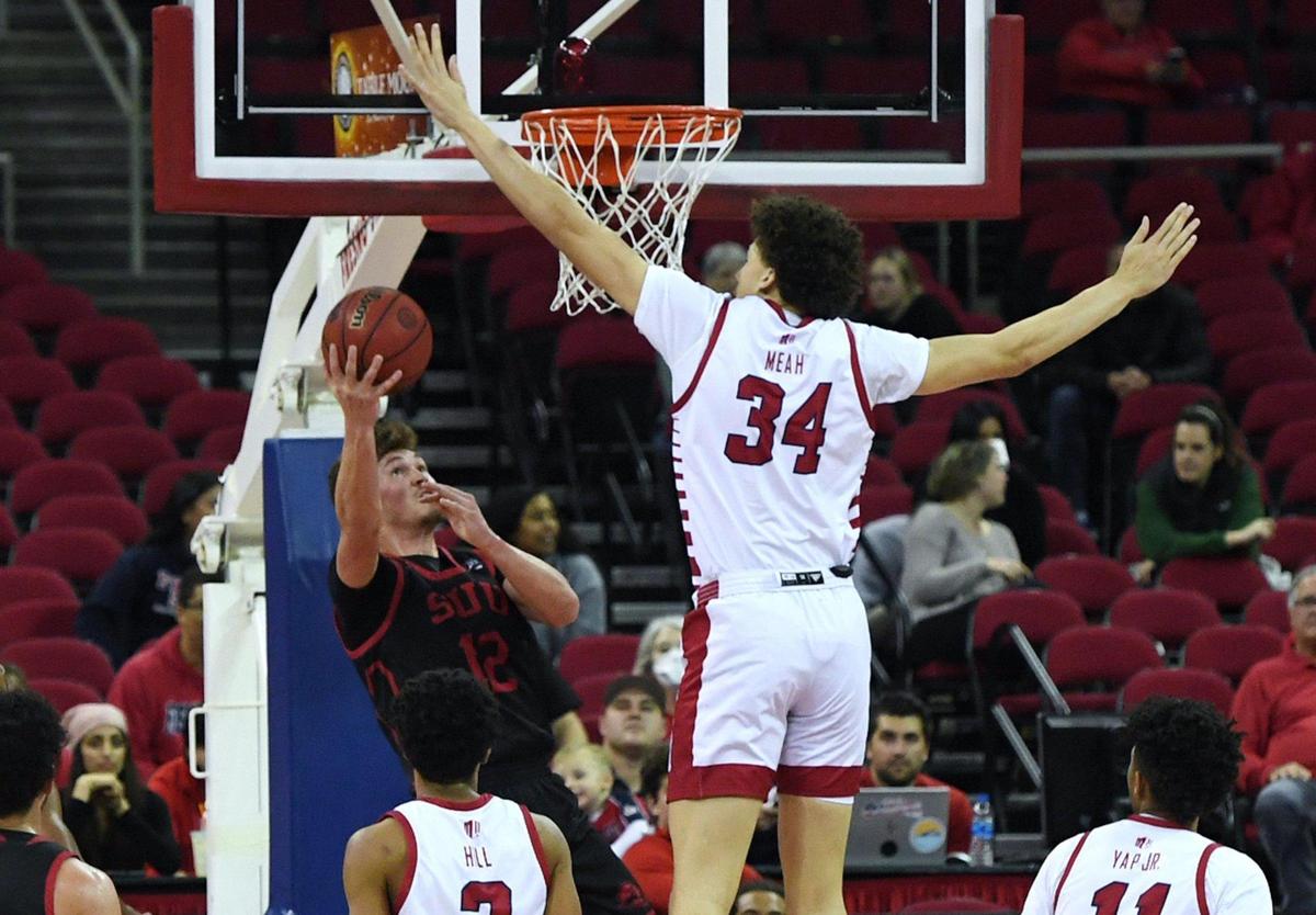 Fresno State center Braxton Meah blocks a shot by Southern Utah’s Maizen Fausett in the Bulldogs;’ 67-48 victory in the semifinals of The Basketball Classic Monday, March 28, 2022 in Fresno.