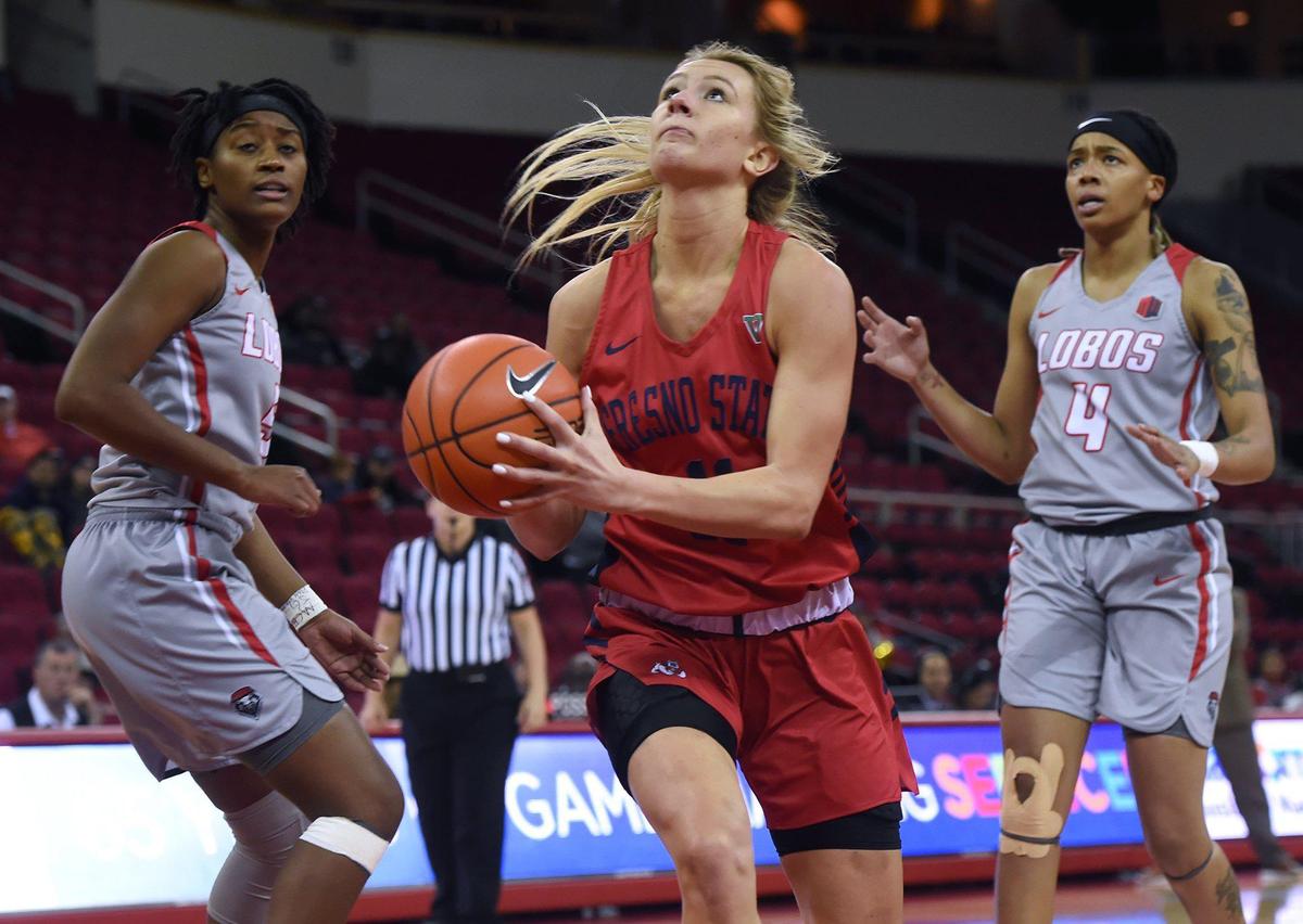 Fresno State’s Maddi Utti, center, goes for the shot with New Mexico’s Jordan Hoesy, left, and Jayla Everett, right, Wednesday, Jan. 8, 2019 in Fresno. Fresno State 84, New Mexico 81 in overtime.